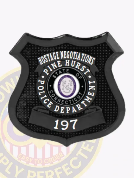 Sleek custom black shield metal badge for Pine Hurst police the hostage negotiations with safety pin attachment, showing a dark black metal badge shaped like a shield, textured background, bold white letters stating "HOSTAGE NEGOTIATIONS" across the top, "PINE HURST POLICE DEPARTMENT" circling the Connecticut state emblem, and "197" prominently displayed below.