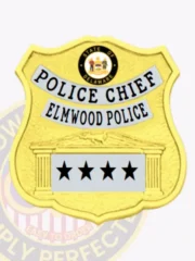 Custom gold shield metal badge with silver panels for Elmwood police the deputy chief with safety pin attachment, showing a bright gold shield with dotted texture, silver panels labeled "POLICE CHIEF" and "ELMWOOD POLICE," the official Delaware seal in color above, and four bold black stars on a bottom silver banner framed by pillar motifs.