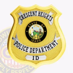 Official custom gold shield metal badge for crescent heights police with polished silver panels displaying black text, colorful idaho state seal at the center, textured gold surface, and safety pin attachment for secure wear.