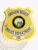 Crescent Heights Police Department’s custom gold shield metal badge accented with silver panels, black lettering on silver banners reading "Police Department ID," a detailed Idaho state insignia in the center, finished with a safety pin attachment.