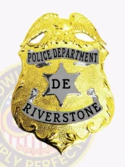 Custom Riverstone Police badge in gold metal with silver panels, displaying a detailed gold eagle on top, black text on silver banners for "POLICE DEPARTMENT" and "RIVERSTONE," a silver six-point star in the middle with "DE," held by safety pin.