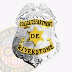 Custom silver eagle top shield metal badge with gold panels for riverstone police, featuring a detailed silver eagle perched atop the shield, gold banners with black text reading "police department" and "riverstone," a central gold six-point star with "de" in black letters, secured with safety pin.