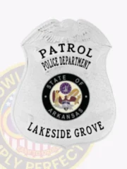 Shield badge in silver metal for Lakeside Grove police patrol, showcasing an embossed eagle at the crest, black uppercase letters "PATROL POLICE DEPARTMENT" and "LAKESIDE GROVE," highlighted by the colorful Arkansas state emblem, fitted with a safety pin fastener.