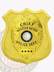 Shiny custom gold shield metal badge with an inner eagle top shield for Houston Metro police the chief with safety pin attachment, presenting a textured gold shield with a prominent gold eagle emblem in the center, black lettering for "CHIEF," "HOUSTON METRO," "POLICE DEPT.," and four black stars on a base banner, surrounding the blue Texas state seal.