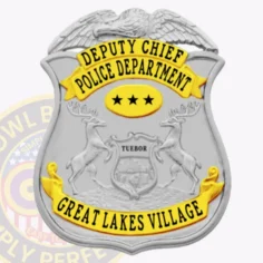 Custom silver eagle top shield metal badge with gold panels for great lakes village police deputy chief, featuring gold banners with black text "deputy chief" and "police department," a gold oval with three black stars in the center, and a gold banner reading "great lakes village," with safety pin attachment.