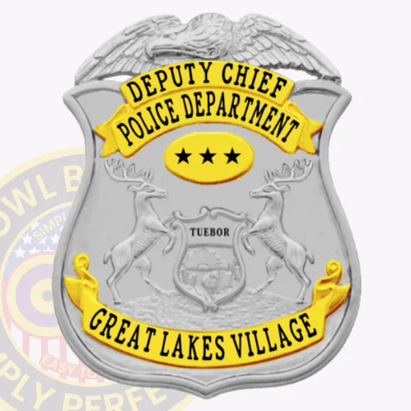 Custom silver eagle top shield metal badge with gold panels for Great Lakes Village police deputy chief, featuring gold banners with black text "DEPUTY CHIEF" and "POLICE DEPARTMENT," a gold oval with three black stars in the center, and a gold banner reading "GREAT LAKES VILLAGE," with safety pin attachment.