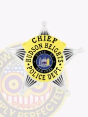 Custom silver 5 point star badge with gold panels for the Hudson Heights police chief, showing “CHIEF” prominently at the top of the gold banner and “HUDSON HEIGHTS POLICE DEPT.” around the state seal, designed with a safety pin attachment.