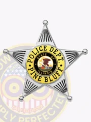 Custom metal badge with a silver five-point star and gold panels for Pine Bluff Police, including black lettering “POLICE DEPT. PINE BLUFF” framing the Illinois state emblem at the center, designed with a safety pin attachment.