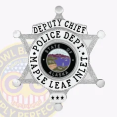 Custom-made silver metal badge shaped as a six-pointed star for maple leaf inlet police deputy chief, displaying "deputy chief" on top, "police dept. " and "maple leaf inlet" surrounding a colorful alaska emblem, accented by three stars at the bottom, attached with a safety pin.