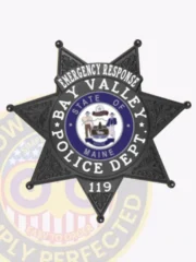 Distinctive black custom metal badge featuring "EMERGENCY RESPONSE" inscribed prominently at the top in bright white text. The badge showcases a detailed star design with a central emblem that includes "BAY VALLEY POLICE DEPT." and "STATE OF MAINE," plus the number "119," all complemented by a reliable safety pin attachment for practicality.