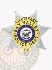 Bright silver custom metal badge adorned with gold accents, showcasing "LIEUTENANT" elegantly at the top in clear black font. The badge features an intricate star design with "BAY VALLEY POLICE DEPT." and "STATE OF MAINE," all secured with a reliable safety pin attachment for ease of use.