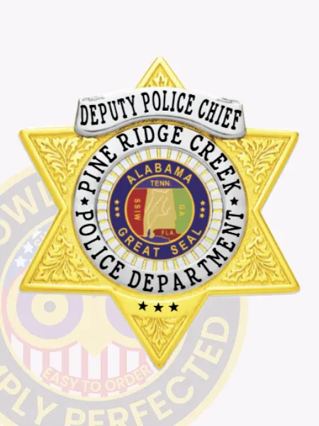 Pine Ridge Creek Deputy Police Chief custom gold 6-point star metal badge with ornate engraved designs on the gold star shape, topped by a silver banner with "Deputy Police Chief" in black letters, and a silver ring surrounding the multicolored Alabama Great Seal and "Pine Ridge Creek Police Department;" includes safety pin on the back.