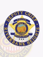 This elegant badge showcases a bold 5-pointed gold star framed by a vibrant blue circle banner. "DEPUTY CHIEF" is displayed at the top, while "RIVERBANK HEIGHTS POLICE DEPARTMENT" features below. The design incorporates blue reverse enamel panels and silver panels, enhancing its overall appearance. The badge also includes a safety pin attachment for easy application.