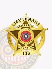 Five-point gold metal badge for Cedar Creek police lieutenant showing a polished star with textured brown center, black text reading "LIEUTENANT," "CEDAR CREEK," and "JUNCTION," surrounding the colorful Texas state emblem that says "STATE OF TEXAS POLICE DEPARTMENT"; the badge number "138" is at the bottom and includes a safety pin attachment.