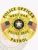 Custom gold 6-point star metal badge for West Oak police officer patrol, featuring bold black text reading "POLICE OFFICER" around the top, a banner with "WEST OAK," and "POLICE DEPT. PATROL" below the Oklahoma state seal in the center, flanked by two American flags, with a safety pin attachment.
