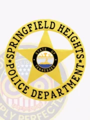 Showcased here is a custom gold badge featuring a prominent 5-point star surrounded by a circular banner displaying "SPRINGFIELD HEIGHTS" on top and "POLICE DEPARTMENT" on the bottom. The Tennessee state seal adds an official touch to the center, representing service and authority. This badge is specifically designed for Springfield Heights Police and features a velcro attachment for secure wearing.