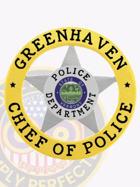This image features a custom silver 5-point star metal badge surrounded by a gold circle banner that states "GREENHAVEN CHIEF OF POLICE." The badge's center displays the state seal of Vermont, emphasizing its importance. Designed with a safety pin attachment, it is perfect for the Greenhaven chief of police.
