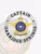 Polished silver circular banner badge for Oakridge Springs police Captain holding a gold five-point star, with "CAPTAIN" and "OAKRIDGE SPRINGS" printed clearly in black around the edge, including a blue Texas state emblem and safety pin attachment.