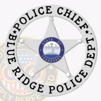 Showcased here is a custom silver badge featuring a prominent 5 pointed star surrounded by a circular banner displaying "POLICE CHIEF" on top and "BLUE RIDGE POLICE DEPT" on the bottom. The Tennessee state seal is highlighted in the center, representing authority and service. This badge is specifically tailored for the Blue Ridge Police chief and includes a safety pin attachment for secure wearing.