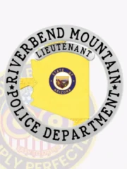 This image highlights a custom Arizona metal badge for the Riverbend Mountain police lieutenant, showcasing a vibrant gold outline of the state of Arizona. Surrounded by a silver circular banner, the badge features the text "RIVERBEND MOUNTAIN POLICE DEPARTMENT" below and "LIEUTENANT" prominently above. A safety pin on the reverse provides convenient attachment.