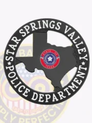 Showcasing a custom Texas metal badge for the Star Springs Valley police, this design highlights a striking black outline of the state of Texas. The badge is framed by a circular banner inscribed with "STAR SPRINGS VALLEY POLICE DEPARTMENT," emphasizing its official capacity. A safety pin attachment ensures reliable wear.