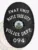This striking custom metal badge in black displays "SWAT UNIT" prominently at the top in bold white font. The center features a circular emblem showcasing the "STATE OF NORTH DAKOTA," surrounded by decorative accents, with "MAPLE TREE CITY," "POLICE DEPT.," and "094" inscribed below. A safety pin attachment ensures it can be securely affixed to uniforms with ease.