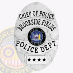 This elegant custom metal badge in silver prominently displays "chief of police" at the top in bold black font, enhanced by stylish design elements. The center includes the emblem for the "state of new york," surrounded by silver details, with "brookside fields," "police dept. ," and three stars inscribed below. A safety pin attachment ensures it can be securely affixed to uniforms.