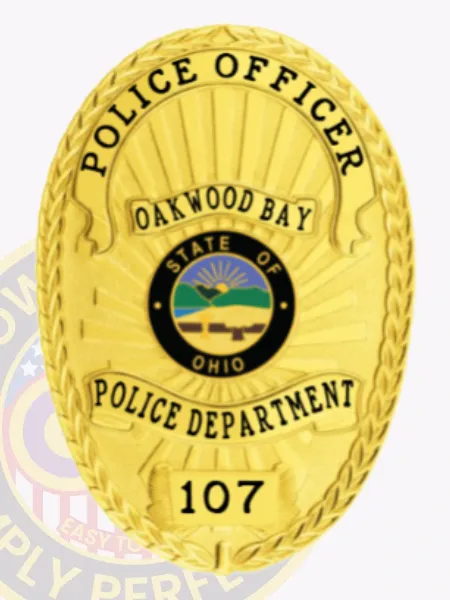 Eye-catching gold custom metal badge showcasing "POLICE OFFICER" prominently at the top in sharp black lettering. The intricate design features "OAKWOOD BAY," "STATE OF OHIO," and a central emblem, as well as "POLICE DEPARTMENT" and the number "107," attached securely with a practical safety pin for convenience.