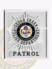 Cedar Creek police patrol badge featuring a silver starburst design in a square flex badge format with a textured background, a black circular Arkansas state emblem in the middle, surrounded by "CEDAR CREEK POLICE DEPARTMENT," and "PATROL" printed in bold black letters below, attached by velcro.