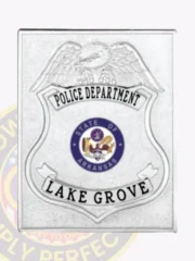 Custom-made silver square metal badge for Lake Grove police department, showcasing a detailed silver eagle above the shield, black text reading "POLICE DEPARTMENT" and "LAKE GROVE" on top and bottom banners, with a blue and gold Arkansas state seal centered, held in place by a safety pin.