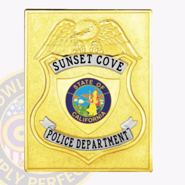 Custom-made gold square metal badge with center shield for Sunset Cove Police Department, adorned by a raised eagle figure, the official multicolored California state seal at its center, and silver scroll banners with black lettering; designed with safety pin attachment.