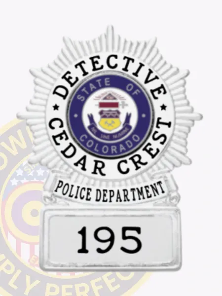 Custom-made silver circle starburst metal badge for Cedar Crest Police detective, adorned with a radiant silver starburst surrounding the colorful Colorado state seal, black text labels around the center, a silver banner below, and a square base displaying "195," designed with safety pin attachment.