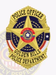Gold shield-shaped metal badge for Golden Hills Police Officer, displaying a central 5-point star surrounding the State of Texas seal, with “Police Officer” at the top and “Golden Hills Police Department” on the bottom, attached by a safety pin.