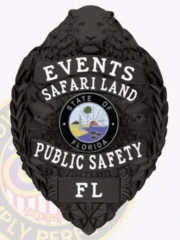 A custom metal badge in black, prominently featuring a lion head at the top, representing strength and authority. The badge displays the word "EVENTS" above "SAFARI LAND," with a central circular emblem that includes the text "STATE OF FLORIDA." Below the emblem, "PUBLIC SAFETY" is featured, and the badge is marked with "FL" at the bottom. The intricate detailing enhances its design, making it a distinctive personalized badge for event officials.