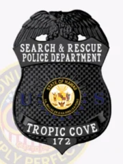 Black shield-shaped metal badge topped with a detailed eagle, gold-bordered State of Hawaii seal in the center, white lettering for Tropic Cove police Search & Rescue unit, including badge number 172, secured by a safety pin attachment.