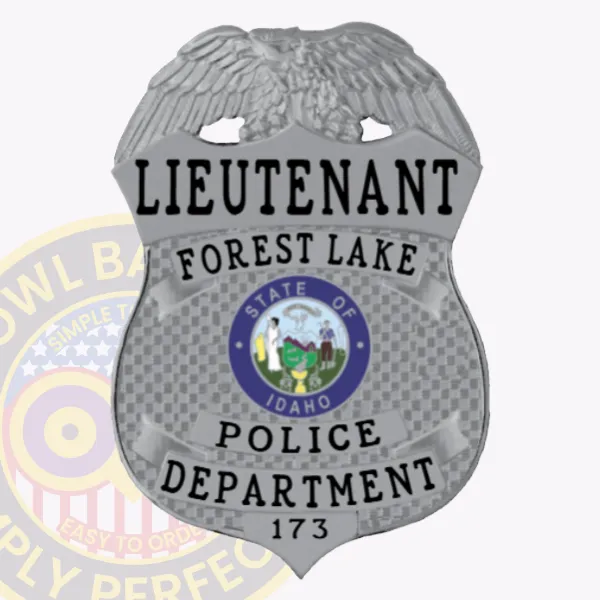 Silver shield-shaped metal badge topped by a detailed silver eagle, labeled for Forest Lake police lieutenant, showing black lettering on silver panels and the Idaho state emblem at the center, equipped with a safety pin fastener.