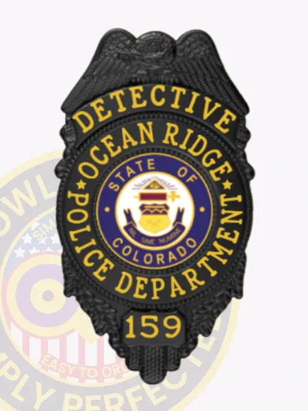 Shield-shaped black metal badge for Ocean Ridge police detective, showing an eagle embossed at the crest, bright yellow letters reading "DETECTIVE OCEAN RIDGE POLICE DEPARTMENT" encircling the colorful Colorado state emblem, with the number "159" below, designed with a safety pin fastener.