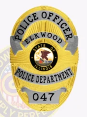 A striking custom metal badge in gold with silver panels and a safety pin attachment, featuring "047" at the bottom to indicate a specific badge number. The top of the badge displays "POLICE DEPARTMENT," alongside "ELKWOOD," creating a cohesive and professional look that highlights its importance in law enforcement.