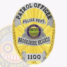 A striking custom metal badge in gold with silver panels and a safety pin attachment, featuring "police dept. " elegantly inscribed at the top. The badge includes "brookshire heights" across the center, showcasing the state seal of vermont and highlighting its polished finish and detailed craftsmanship for law enforcement professionals.