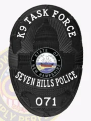 This custom metal badge in black showcases "K9 TASK FORCE" boldly at the top. The centerpiece depicts the New Hampshire state capitol, framed by a circular emblem with "STATE OF NEW HAMPSHIRE" inside. The badge features "SEVEN HILLS POLICE" and the number "071," along with a safety pin attachment for convenient fastening.