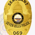 Official Oval Shield with Building Center, Sunburst Background, 3 Text panels, Ribbon Edge Badge view 2