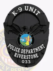 An elegant custom metal badge in black presents a classic oval design with detailed engravings. The words "K-9 UNIT" are prominently displayed at the top in striking white font. The center showcases the California state emblem, framed by "POLICE DEPARTMENT" and "RIVERSTONE." The lower part includes "033," all in clear white text. A safety pin attachment allows for convenient wear.