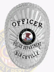 An elegant custom metal badge in silver with safety pin attachment showcases "OFFICER" prominently at the top in striking black text. Beneath, "POLICE DEPARTMENT" stands out clearly, with "BIRCHVILLE" displayed below. The central design features the state seal of Illinois, adding to the badge's official appearance.