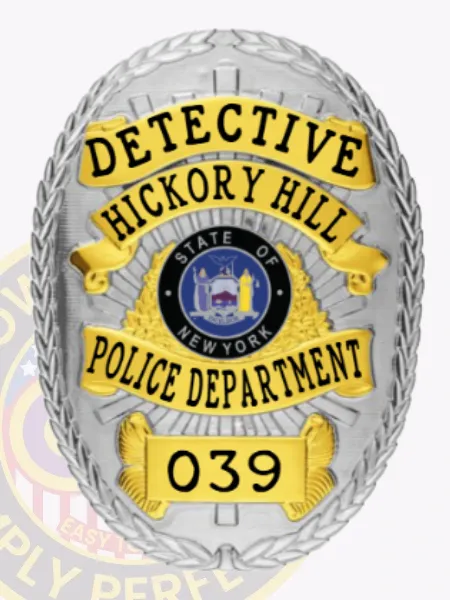 A stylish custom metal badge in silver with gold accents and with safety pin attachment features "DETECTIVE" prominently at the top in bright yellow lettering. The badge includes "HICKORY HILL" just below, with the New York state seal presented in vivid detail at the center. "POLICE DEPARTMENT" elegantly arcs beneath it, and the number "039" completes the badge's design at the bottom.