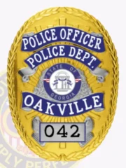 A distinctive custom metal badge in gold with reverse enamel blue accents and with safety pin attachment displays "POLICE OFFICER" prominently at the top in bold white text. Below it, "POLICE DEPT." is featured clearly, while "OAKVILLE" appears in striking blue. The central design includes the state seal of Georgia, and "042" is elegantly positioned in a contrasting box at the bottom.