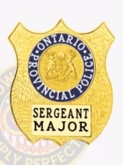 Custom gold metal badge in shield design for Ontario Provincial Police Sergeant Major, featuring the provincial crest encircled by blue text and a cream rectangular panel with black “Sergeant Major” lettering, secured with safety pin.