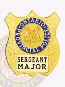 Custom gold metal badge in shield design for ontario provincial police sergeant major, featuring the provincial crest encircled by blue text and a cream rectangular panel with black “sergeant major” lettering, secured with safety pin.