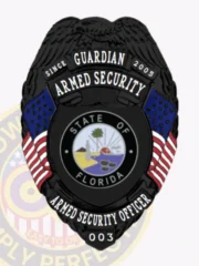 Showcased here is a striking black custom metal badge designed for armed security personnel. It features the words "Guardian Armed Security" arching gracefully over the Florida state seal at the center. The badge is accented with blue stars and red stripes on either side, and marked with "Armed Security Officer 003" below. A safety pin attachment ensures it can be easily fastened to clothing.