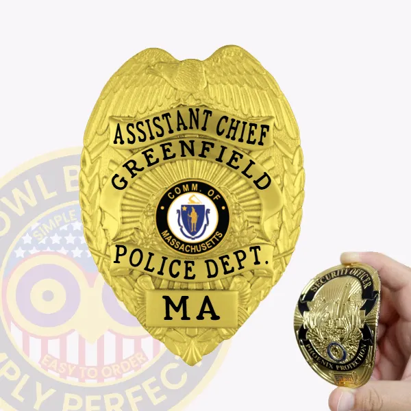 Custom gold eagle top flex badge for Greenfield Police Assistant Chief, featuring a detailed gold eagle crest at the top, black text reading "ASSISTANT CHIEF GREENFIELD POLICE DEPT.," with the Massachusetts state seal in the center and "MA" at the bottom, attached with Velcro.