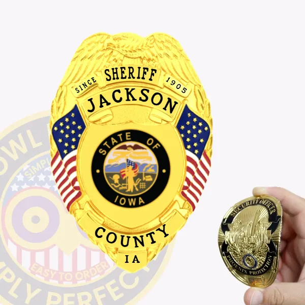 A custom flex badge in gold prominently displaying "SHERIFF" at the top, along with the name "JACKSON" and "SINCE 1905." The center features the state seal of Iowa, surrounded by decorative blue panels and American flags on either side. Below, the badge reads "COUNTY IA." In the foreground, a hand holds a smaller gold badge labeled "SECURITY OFFICER," highlighting the contrast between the two badges. The vibrant gold finish and intricate details emphasize the badge's official significance and authority.